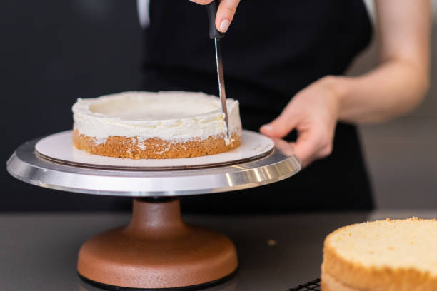 istock Female confectioner making delicious custom cake for wedding celebration 1498194997