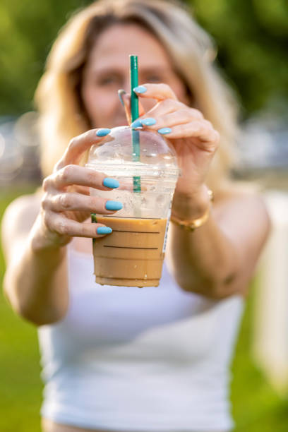 Woman holding her iced coffee