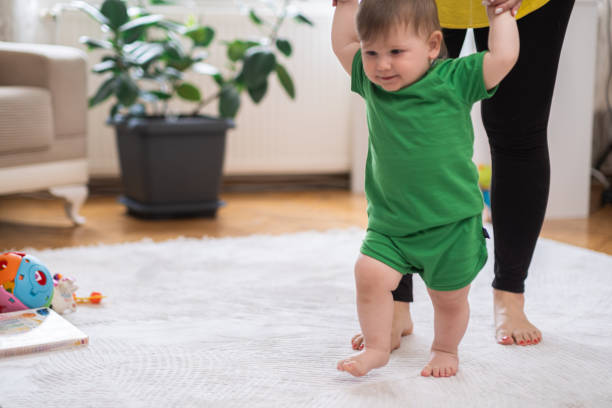 istock Loving mom helping chubby little son developing new skills at home 1498202987