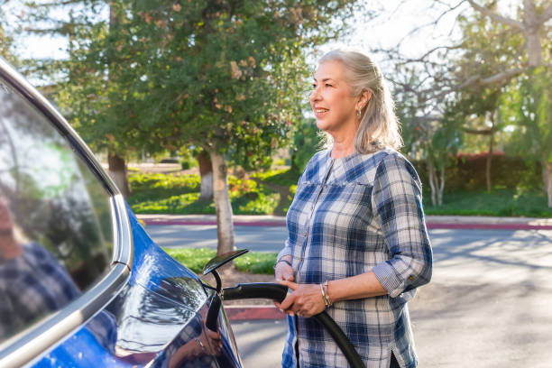 istock Retired woman charging her electric car 1498209914