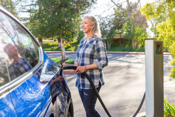 istock Retired woman charging her electric car 1498209916