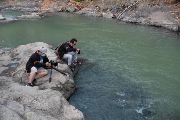 Yogyakarta, Indonesia, Sep 14, 2021. Two men are hunting for a shooting angle in the Lava Bantal river area.