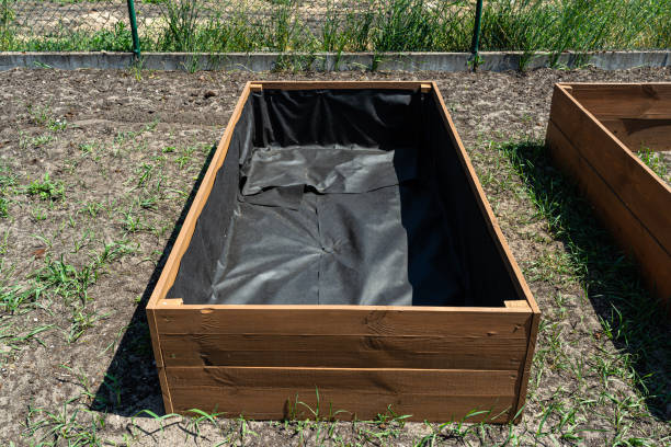 istock Ready wooden boxes for vegetables lined with agrotextile from the inside. 1498217209