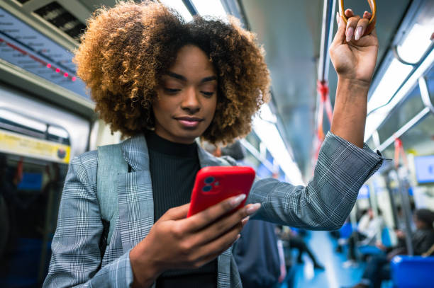 istock A  woman using her cell phone on the subway 1498219716