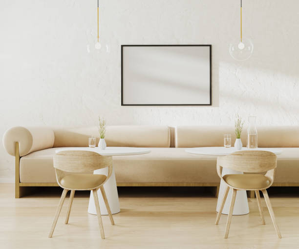 istock Picture frame mock up above light beige sofa in cafe with round coffee tables and chairs, 3d rendering 1498221541