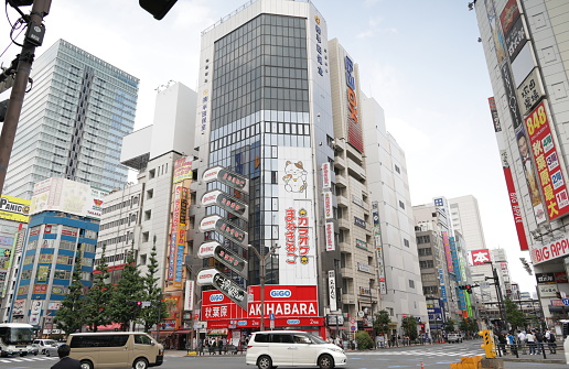 May 22, 2023 - Chiyoda City, Japan: Traffic and pedestrians go through the intersection on 1 Chome Sotokanda and Akihabara Station Minami-dori Street. Spring afternoon in the vibrant shopping district.