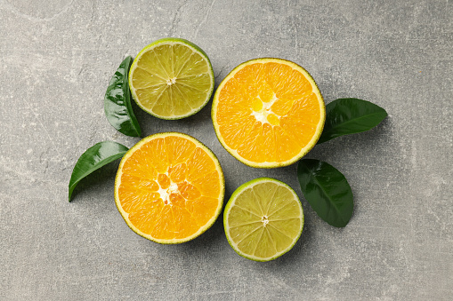 Citrus fruits cut arrangement oranges tangerines lime lemon and grapefruit with leaves isolated on white background leaving copy space