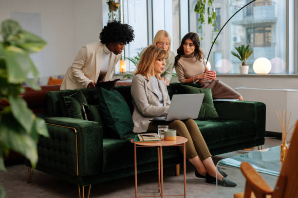 istock Businesswomen working in office lounge. 1498226196