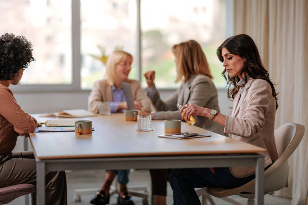istock Woman pouring alcohol into cup at work. 1498226402