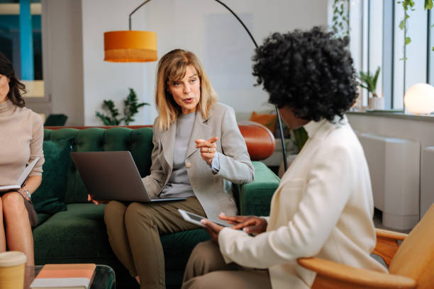 istock Female manager with team in office lounge. 1498227822