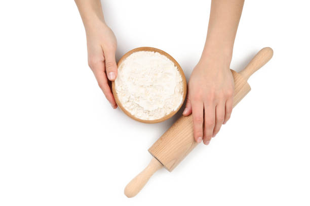 istock Female hands with rolling pin and flour isolated on white background 1498229870