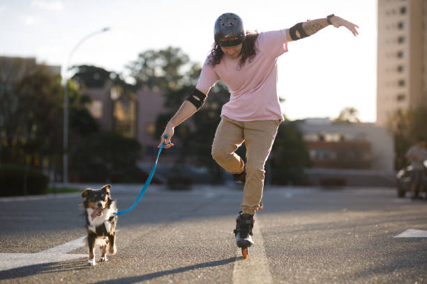 Man roller blading with his mixed-breed dog