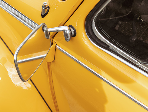 Close-up of wing mirror of a classic German car, very well mantained.