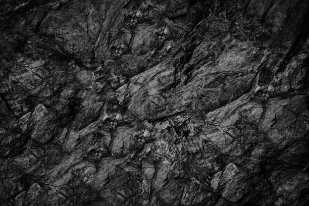 istock Black white rock texture. Dark gray stone granite background. Cracked mountain surface. Close-up. 1498232404