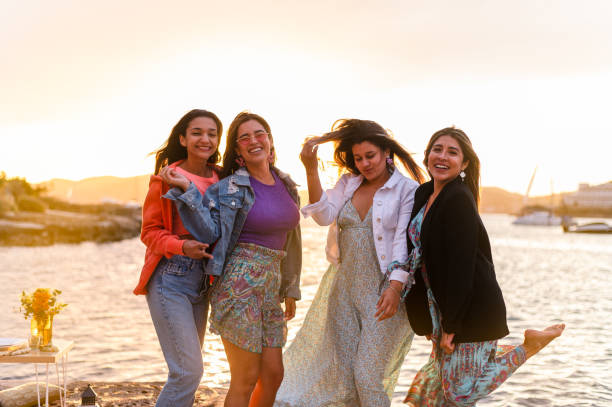istock Playful women posing next to the ocean during sunset 1498233713