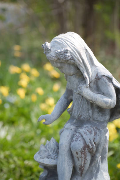 istock statue and yellow flowers 1498233842