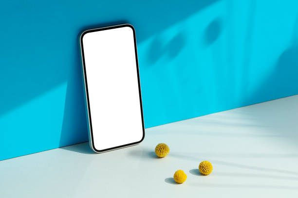 istock Smartphone mockup on yellow background with floral shadows 1498234657