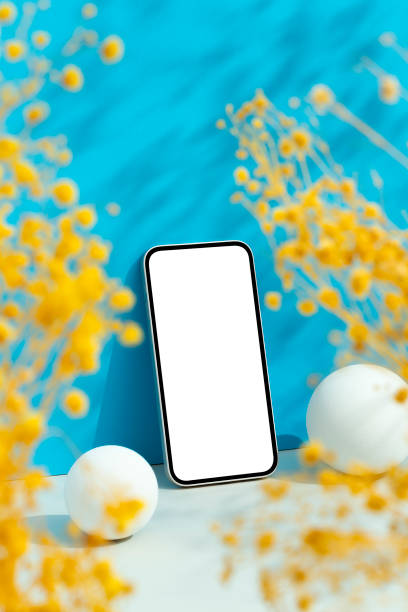 Smartphone mockup on blue background with yellow flowers