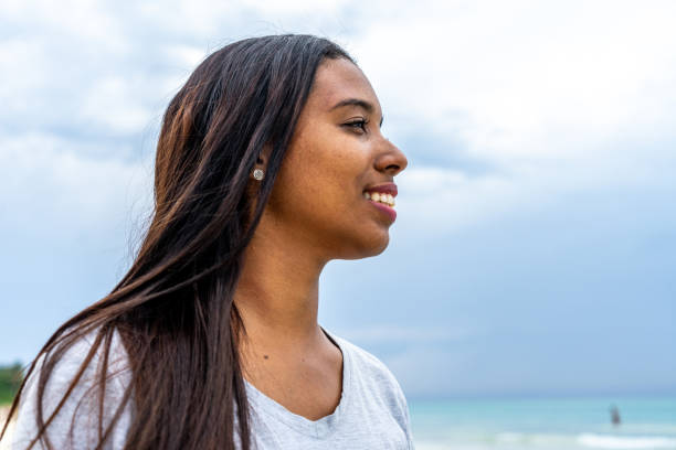 istock Young woman looking away at the beach 1498236739