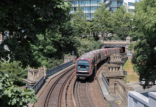 Train (Hamburg Rapid Transit System) passing bridge and enters the tunnel