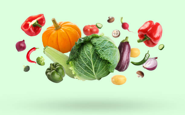 istock Many different fresh vegetables falling on pale light green background 1498236960