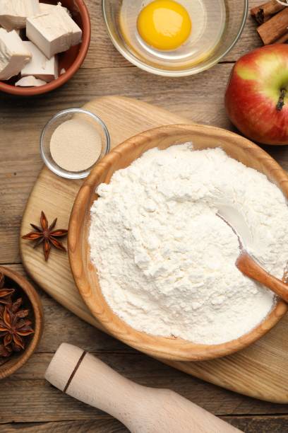 istock Flat lay composition with yeast cake, rolling pin and ingredients on wooden table. Making pie 1498237130