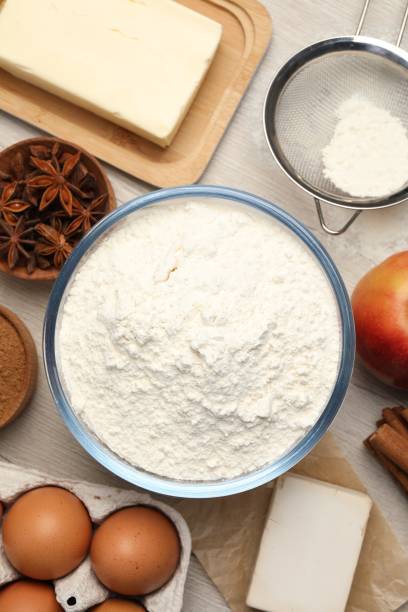 istock Flat lay composition with flour and different ingredients on white wooden table. Yeast pastry 1498237138