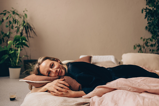 Young woman sleeping on soft pillow in fresh spring grass