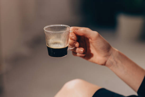 istock Anonymous White Woman Holding a Small Cup of Black Coffee 1498239915