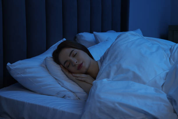 istock Beautiful young woman sleeping in bed at night 1498242355