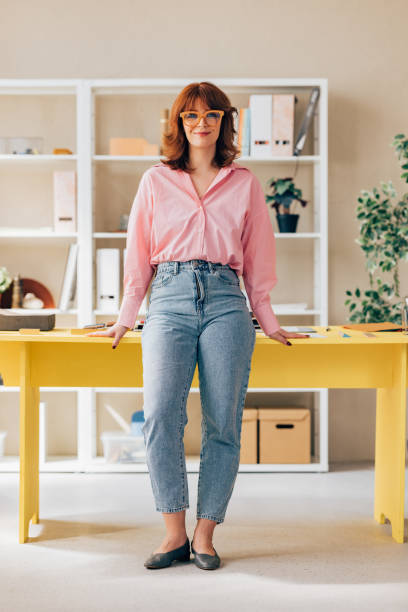 Smiling Female Entrepreneur Standing in her Office