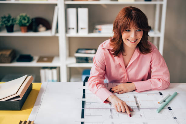 istock Happy Woman Architect Working on her Project in the Office 1498243534