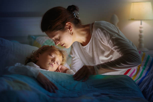 istock Child sleeping in dark bedroom. Little boy napping 1498244808