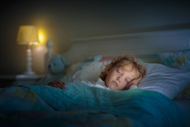 istock Child sleeping in dark bedroom. Little boy napping 1498245257