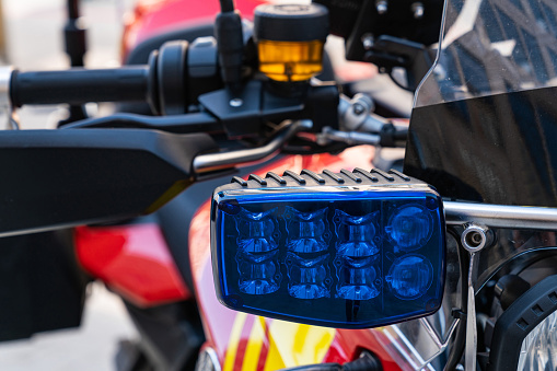 Close-up view of a blue flashing light on a rescue motorcycle.