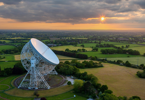 Goostrey, Cheshire, United Kingdom. 05.22.2023 Sunset reflects against the Lovell Telescope, Cheshire. Aerial Image. 22nd May 2023.