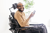Disabled Black Man Using Smartphone at Home