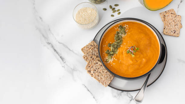 istock A bowl of pumpkin soup with mashed potatoes and seeds. Autumn menu. Copy space 1498258236