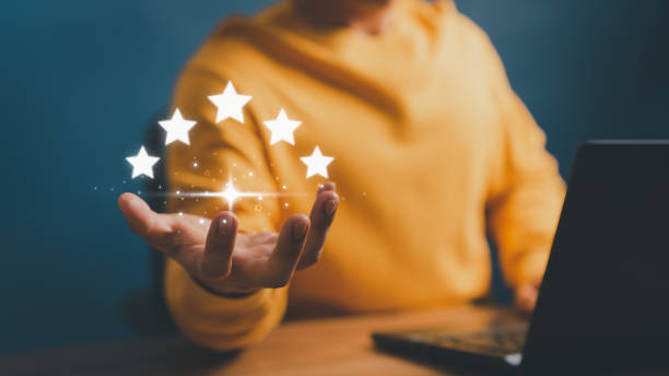 istock Client man hand showing the star icon to complete five stars. Assessment customer service giving the best rating, service feedback, satisfaction and testimonial concept. 1498265584