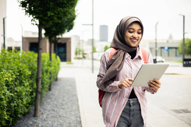 istock Woman using digital tablet outdoors 1498266487