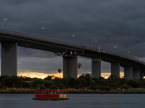 Melbourne skyline, Westgate Bridge and early morning hot air balloons and the Westgate punt