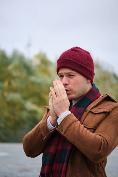 istock Latin young man rubbing his hands to get some warmth during winter. 1498270702