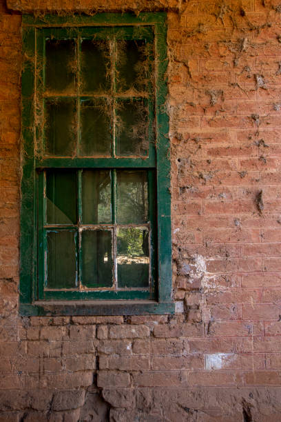 istock Texture of brick wall and window with spider web in old historic abandoned train station 1498273658