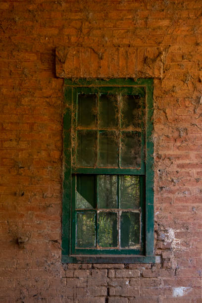istock Texture of brick wall and window with spider web in old historic abandoned train station 1498273670