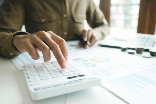 istock Accountant using calculator for calculate finance report in office. 1498287314