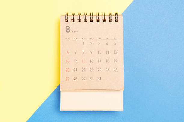 istock Brown calendar on a yellow and blue background close-up, planning concept. 1498289625