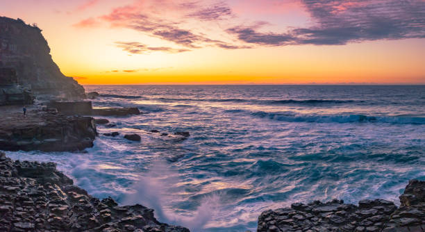 istock Ocean sunrise with rock platform and clouds 1498299168