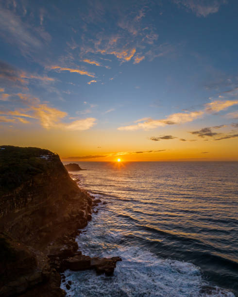 istock Ocean sunrise with rock platform and clouds 1498299233