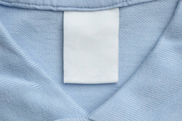 istock White blank laundry care clothes label on blue shirt fabric background 1498302149