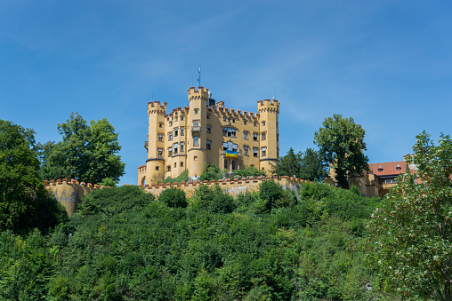 Schwangau, Germany - August 2, 2022: Hohenschwangau Castle, Schloss Hohenschwangau in German, a 19th-century palace in southern Germany, was the childhood residence of King Ludwig II of Bavaria.